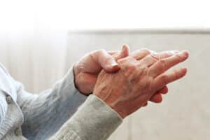A close-up shot of an elderly woman's hands in a nursing home