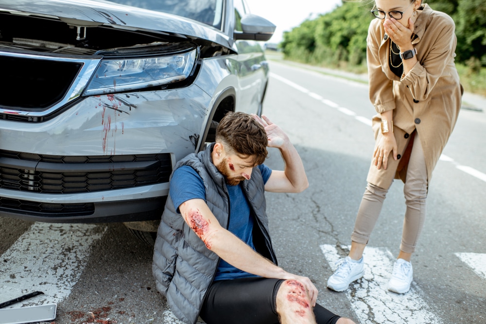 A woman standing over a man after a pedestrian accident in Philadelphia
