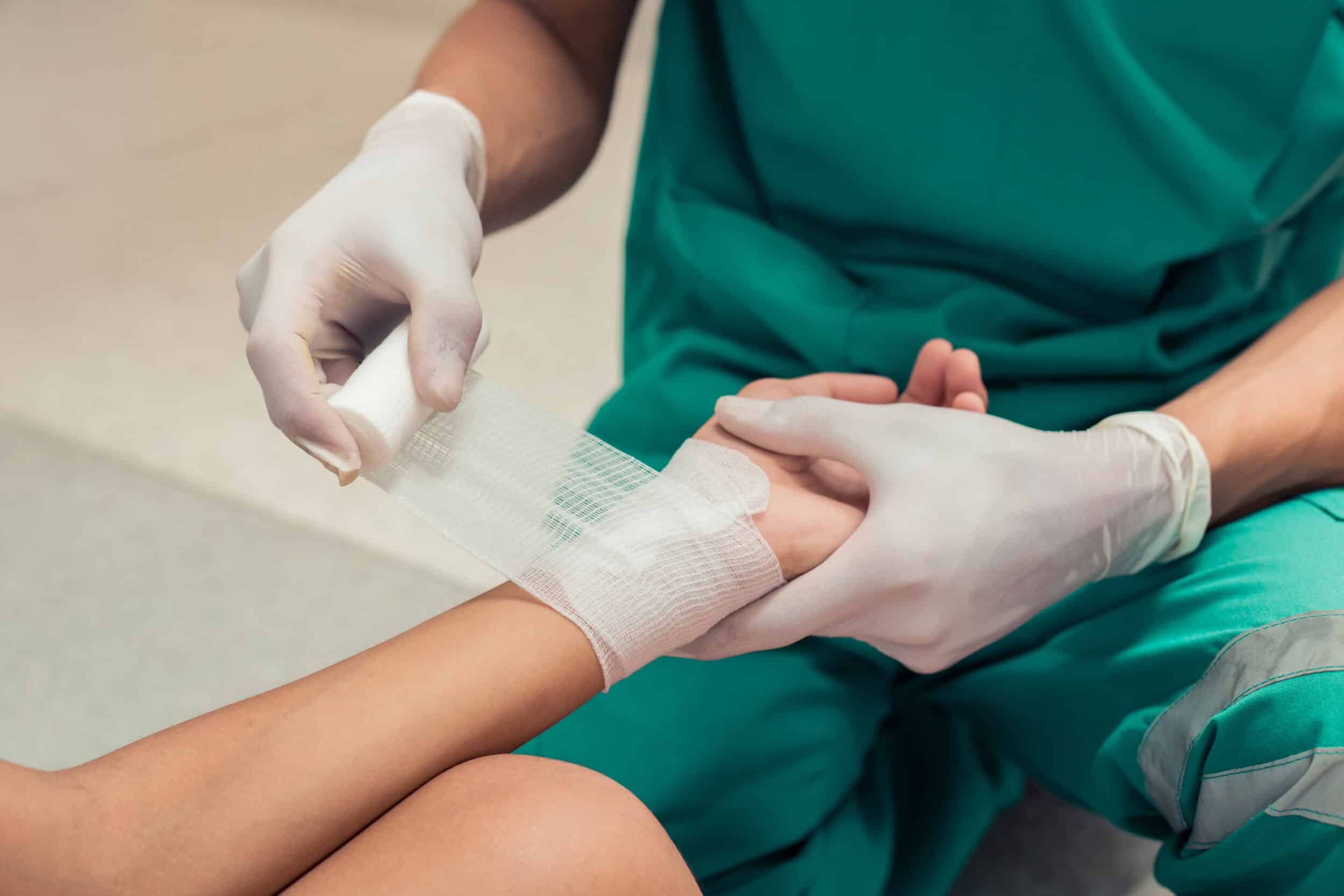 A doctor wrapping a burn injury victim's wrist